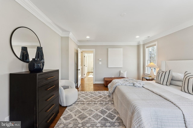 bedroom with hardwood / wood-style floors and ornamental molding