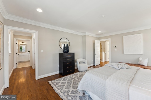 bedroom with dark hardwood / wood-style flooring, crown molding, and connected bathroom