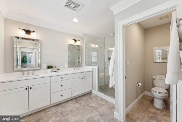 bathroom featuring crown molding, plenty of natural light, toilet, vanity, and a shower with shower door