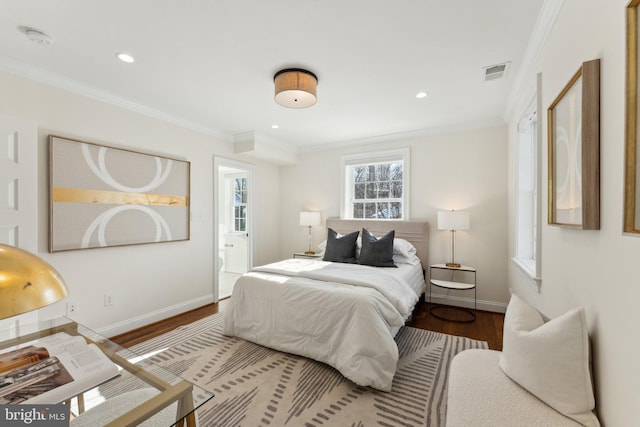 bedroom featuring hardwood / wood-style floors, ensuite bathroom, and ornamental molding