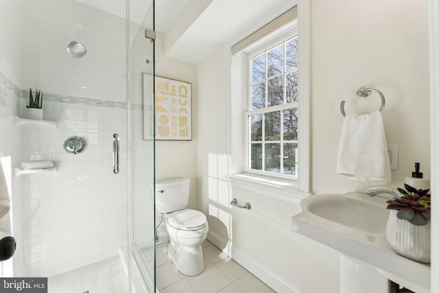 bathroom with sink, tile patterned flooring, an enclosed shower, and toilet