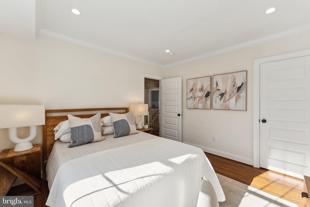 bedroom with hardwood / wood-style flooring and crown molding