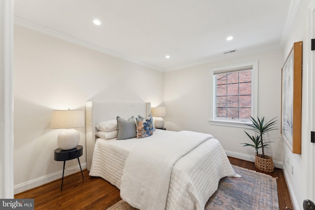 bedroom with dark hardwood / wood-style flooring and ornamental molding