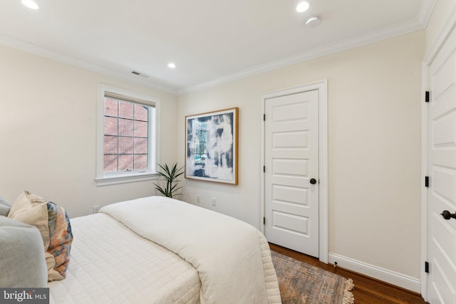 bedroom featuring crown molding and dark hardwood / wood-style flooring