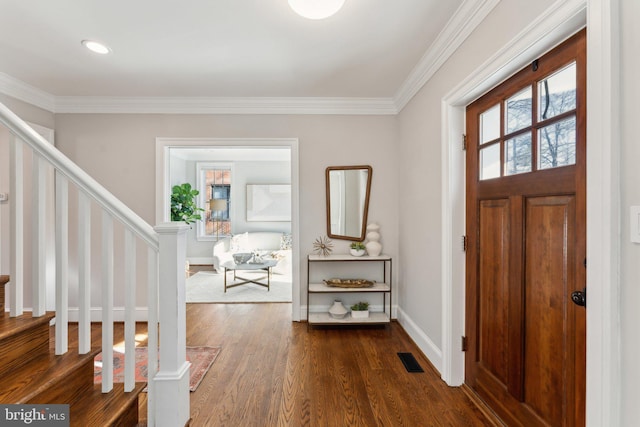 foyer entrance featuring ornamental molding and dark wood-type flooring