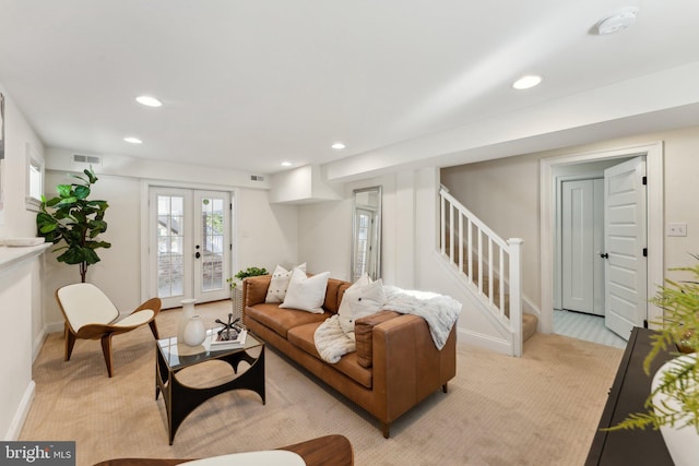 living room featuring light carpet and french doors