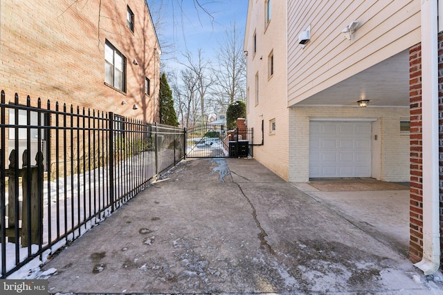 view of home's exterior with a garage and cooling unit