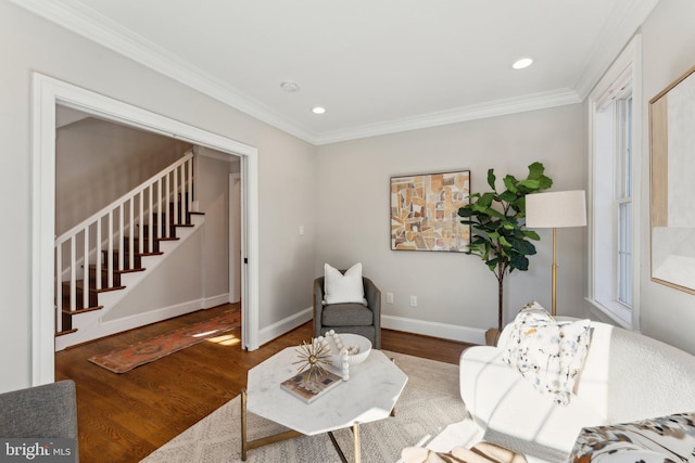 sitting room with plenty of natural light, wood-type flooring, and ornamental molding