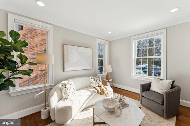 living room featuring hardwood / wood-style flooring and crown molding