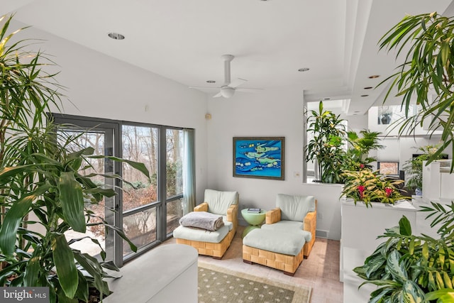 living area featuring ceiling fan and light hardwood / wood-style floors