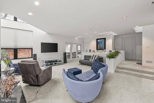 carpeted living room featuring lofted ceiling