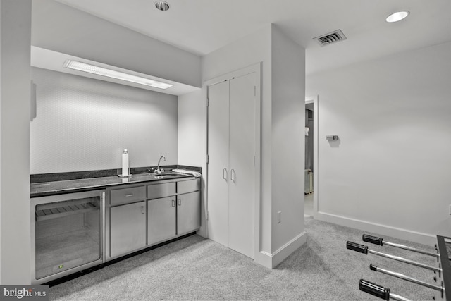 bathroom with sink and wine cooler