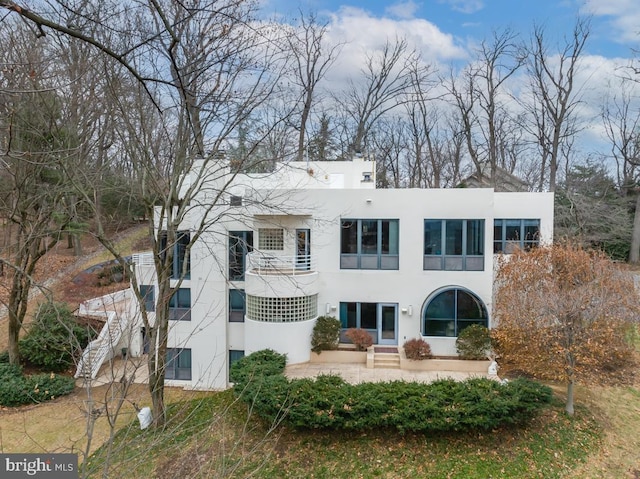 back of house with a patio