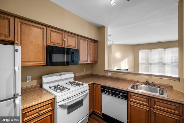 kitchen featuring white appliances and sink