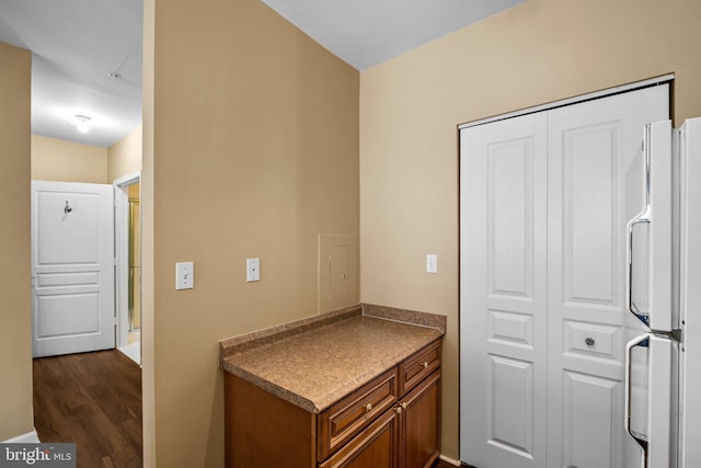 interior space with dark hardwood / wood-style flooring and white fridge