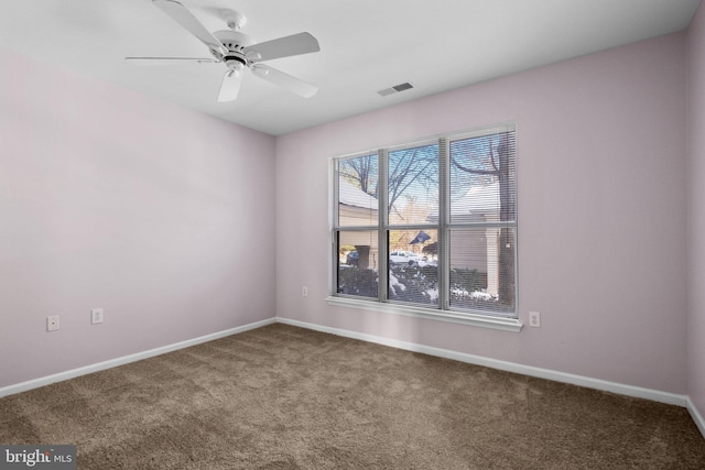 carpeted spare room featuring ceiling fan