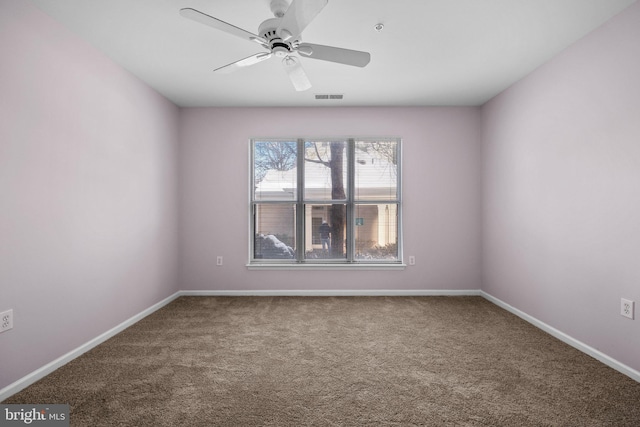 empty room featuring carpet floors and ceiling fan