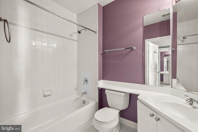 full bathroom featuring vanity, tiled shower / bath combo, and toilet