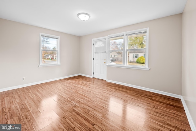 unfurnished room with hardwood / wood-style floors