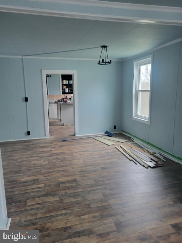 unfurnished dining area featuring crown molding and dark wood-type flooring