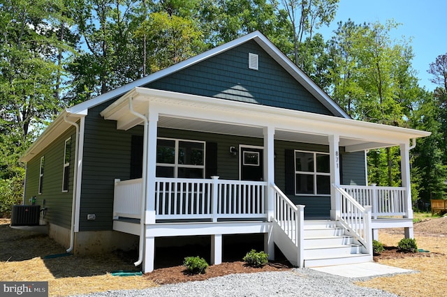 bungalow-style home with covered porch and central AC unit