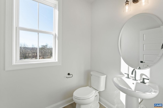 bathroom featuring toilet and sink