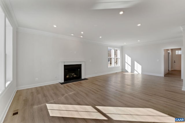 unfurnished living room with light hardwood / wood-style floors and ornamental molding