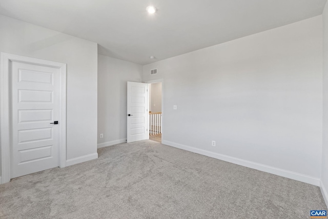 unfurnished room with light carpet