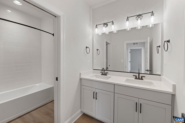 bathroom with vanity, wood-type flooring, and  shower combination