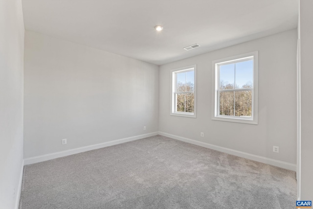 unfurnished room featuring light colored carpet