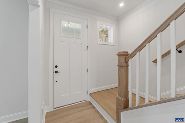 entrance foyer featuring light hardwood / wood-style floors and ornamental molding