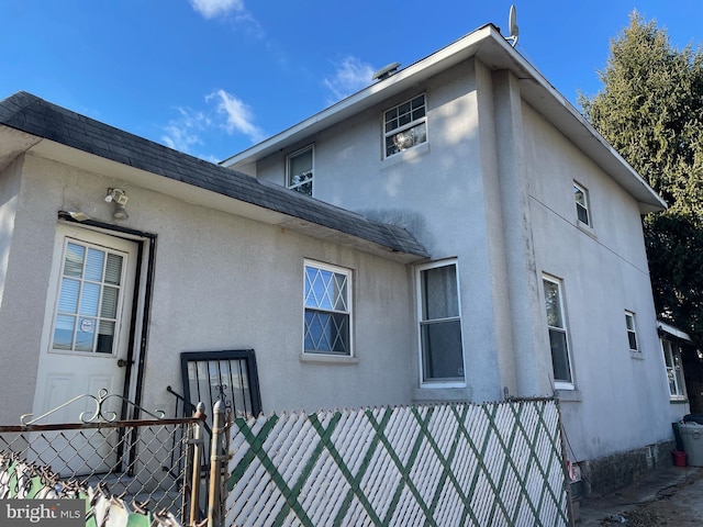 6701 Charles St, Philadelphia, PA 19135 - view of property exterior featuring stucco siding and a gate