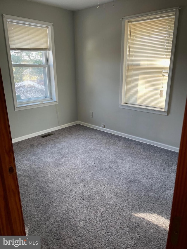 empty room featuring dark carpet