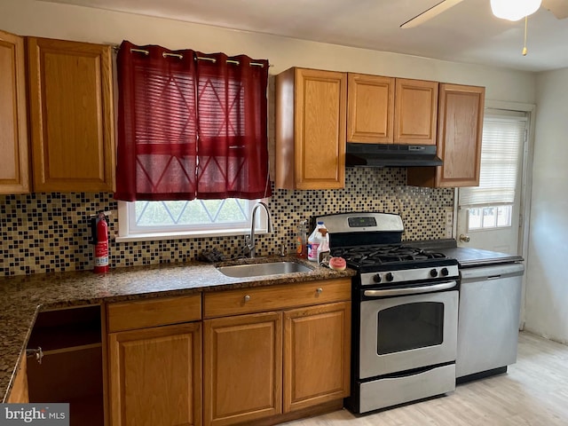 kitchen with backsplash, ceiling fan, sink, and appliances with stainless steel finishes