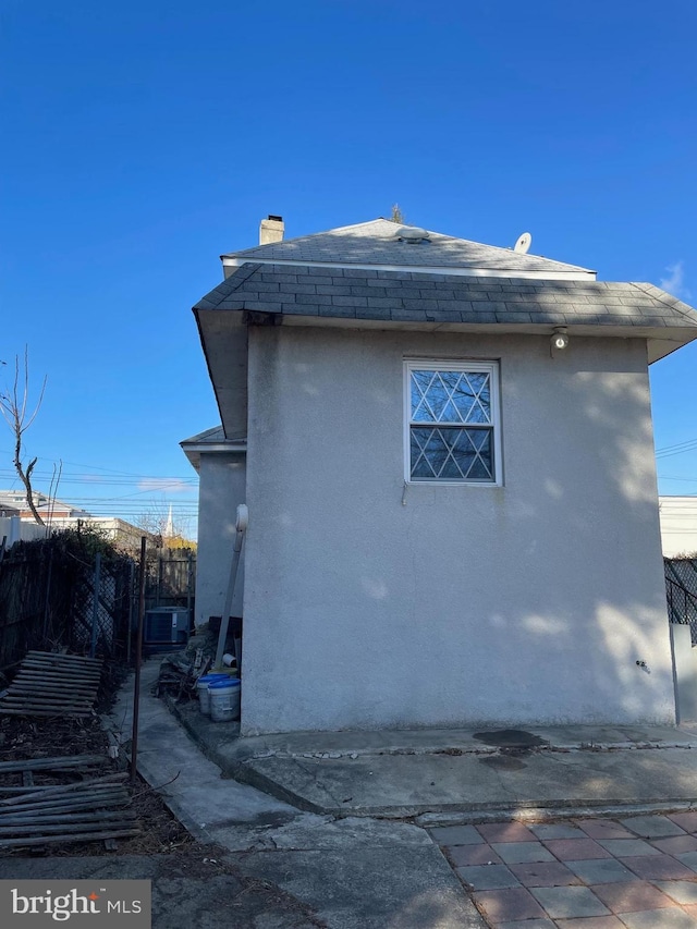 6701 Charles St, Philadelphia, PA 19135 - view of home's exterior featuring stucco siding and roof with shingles