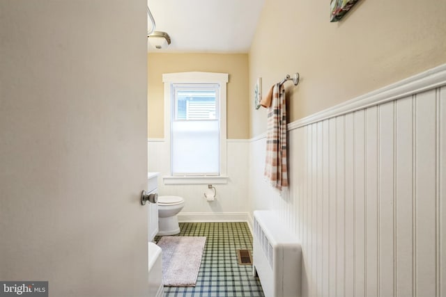 bathroom featuring toilet and radiator