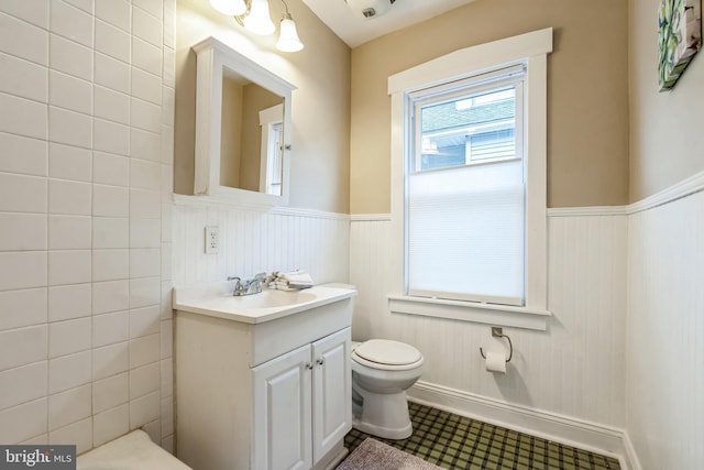 bathroom with tile patterned flooring, vanity, and toilet