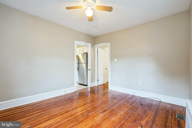 spare room featuring hardwood / wood-style flooring and ceiling fan