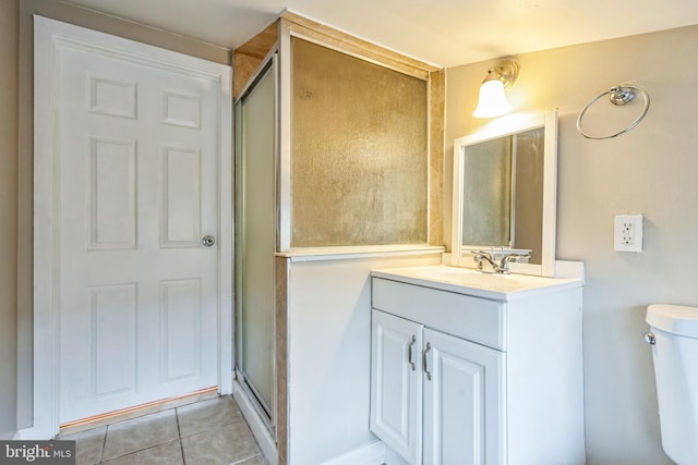 bathroom with tile patterned floors, vanity, toilet, and walk in shower