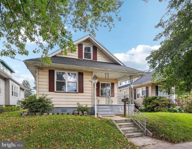 bungalow featuring a front lawn and a porch