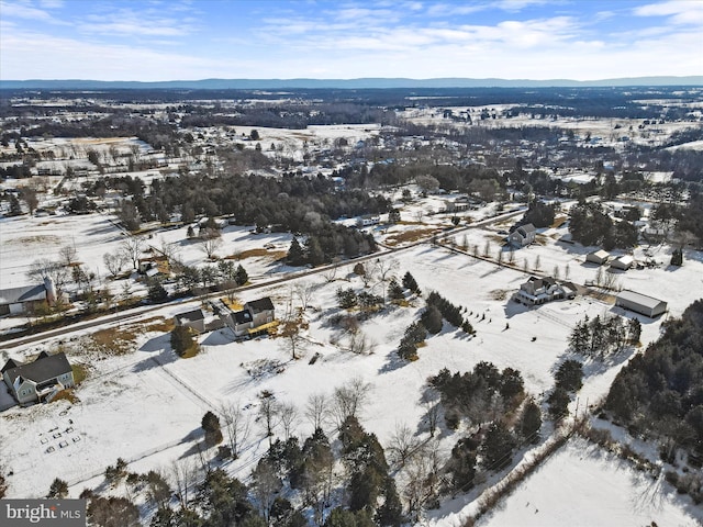 snowy aerial view featuring a mountain view