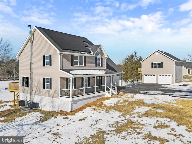 exterior space with central AC, a garage, and covered porch