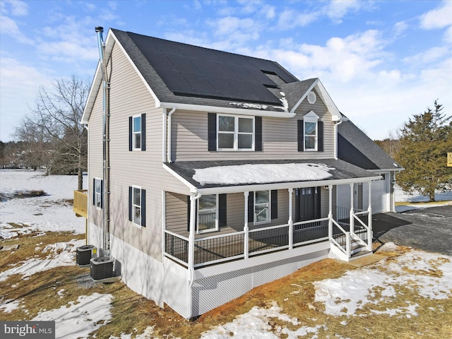 exterior space with central AC, a porch, and solar panels