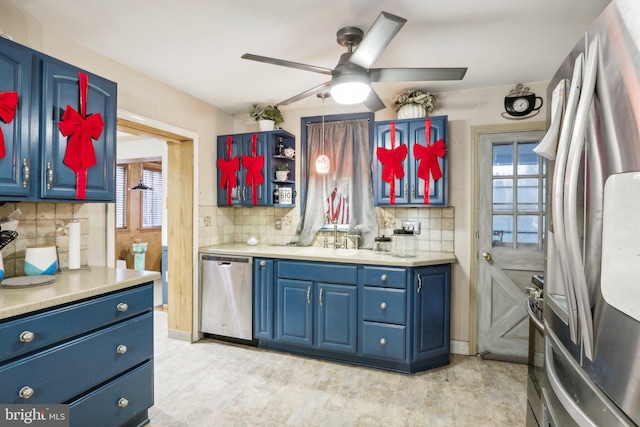 kitchen featuring backsplash, a wealth of natural light, and stainless steel appliances