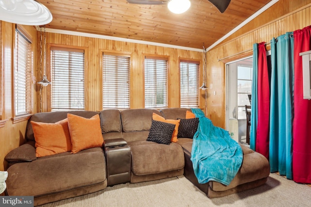 carpeted living room featuring wooden walls, vaulted ceiling, crown molding, and wood ceiling