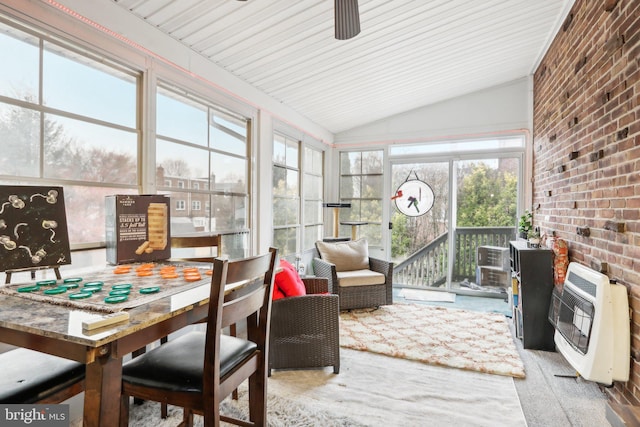 sunroom / solarium with heating unit, plenty of natural light, wood ceiling, and vaulted ceiling