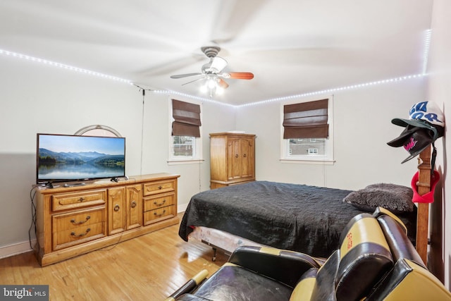 bedroom with ceiling fan and light hardwood / wood-style flooring