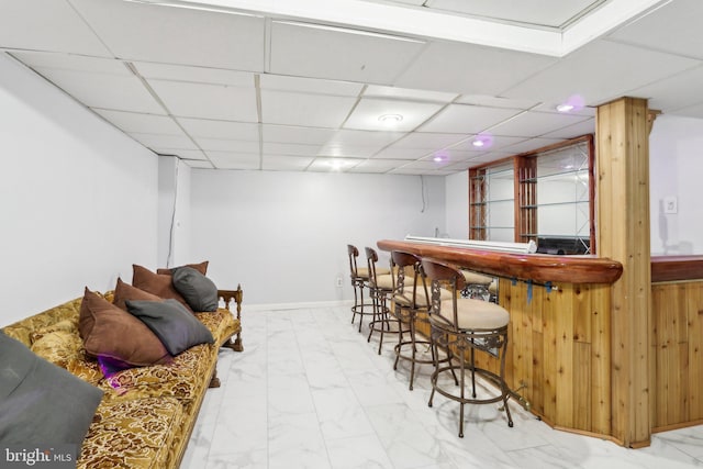 bar featuring a paneled ceiling