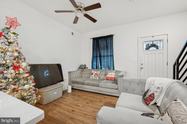 living room featuring ceiling fan and light hardwood / wood-style flooring