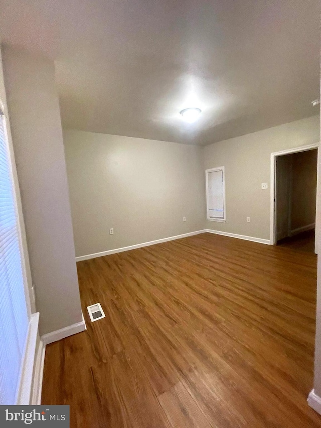 empty room with wood-type flooring